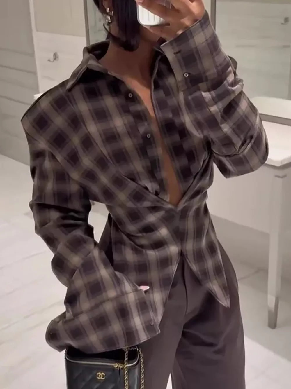 Chic ruched plaid long sleeve shirt with button front and cuffs.