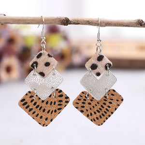 Textured leopard print drop earrings with silver diamond shapes.