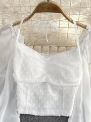 White Swiss dot maternity blouse with ruffled neckline and tie halter.