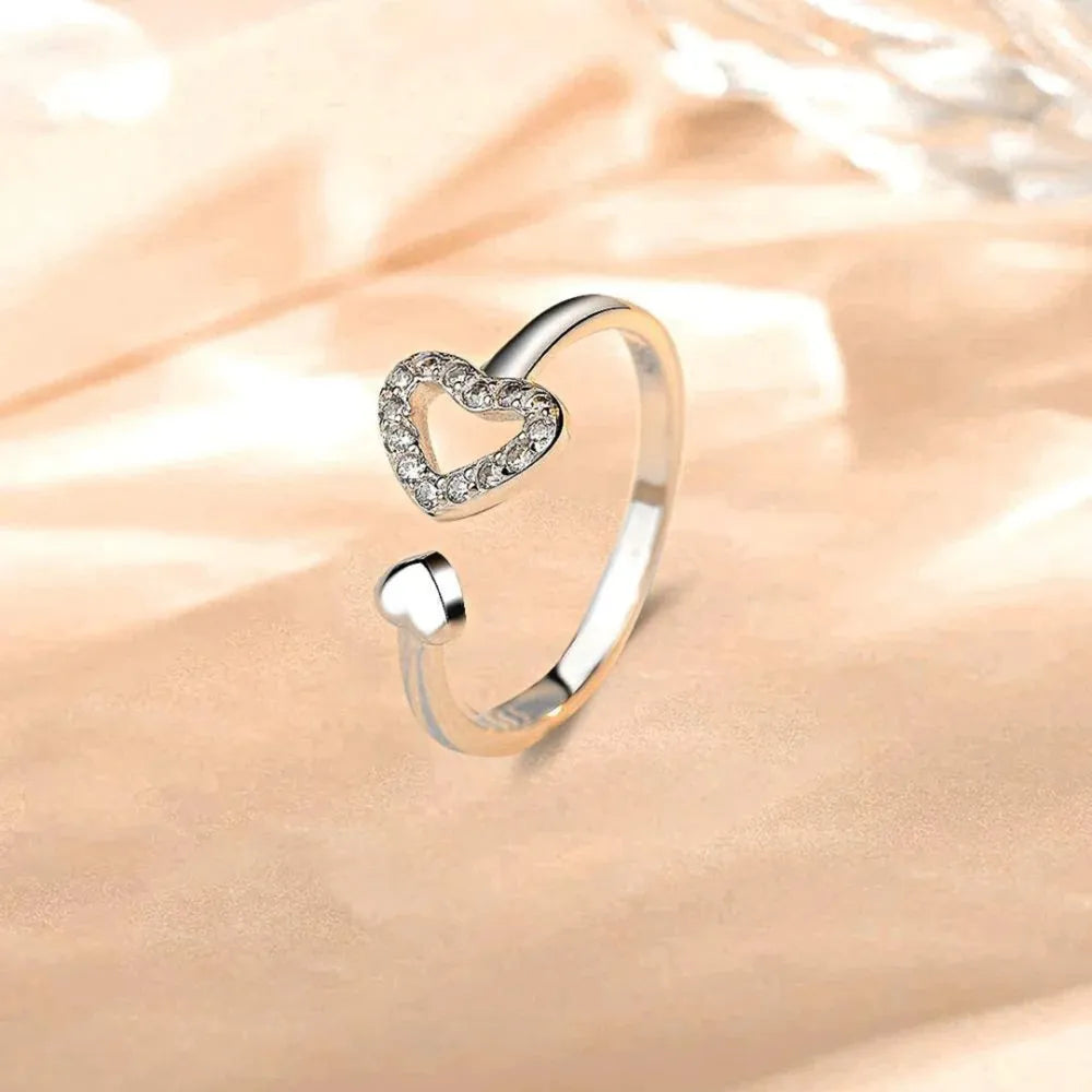 Open heart pavé ring in silver with a smaller heart accent.