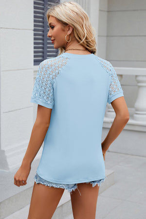 Light blue ribbed tee with lace raglan sleeves and a crew neck.