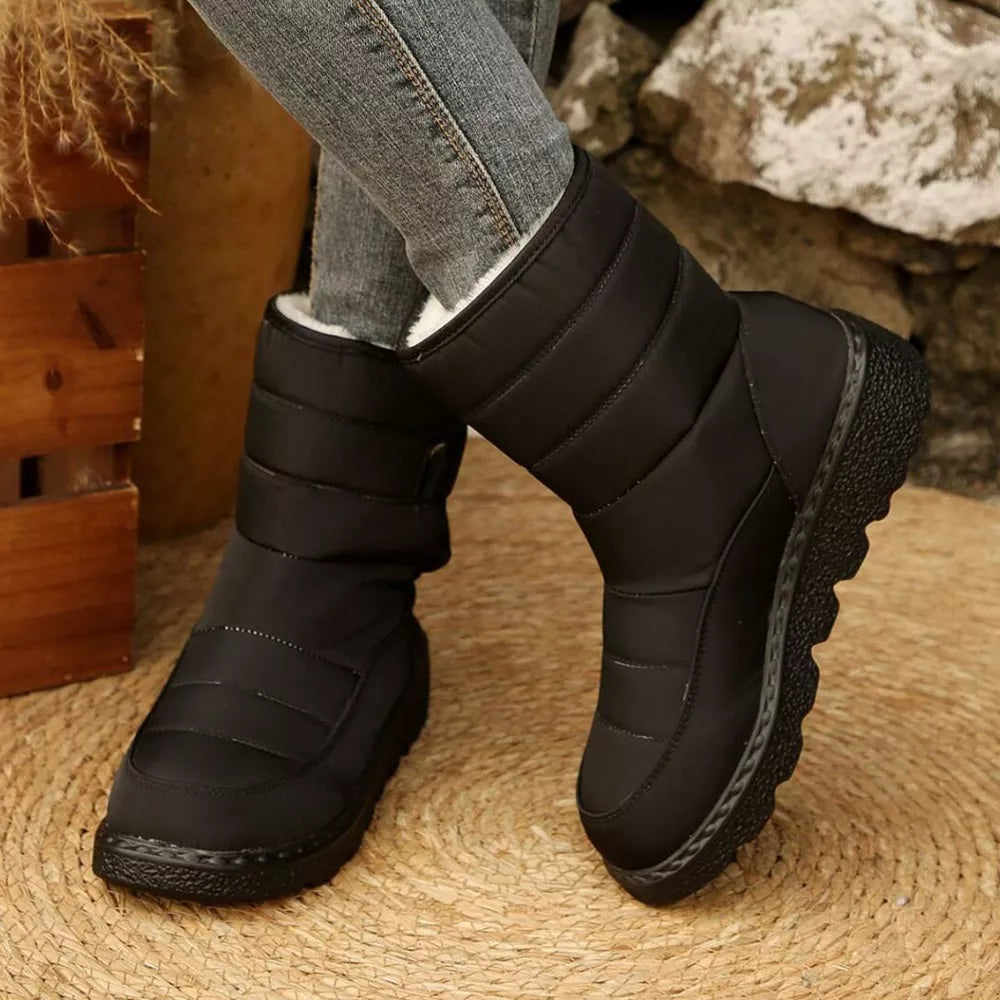 Black quilted round toe platform boots with adjustable strap and chunky sole.