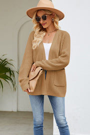 Khaki waffle knit cardigan with patch pockets and open front, styled with a white top and jeans.