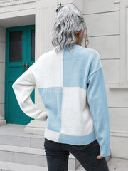 Colorblock knit sweater with checkerboard pattern in pastel blue and white acrylic.