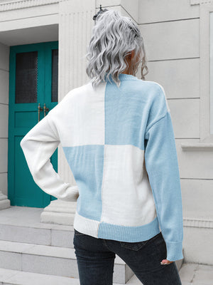Colorblock knit sweater with checkerboard pattern in pastel blue and white acrylic.