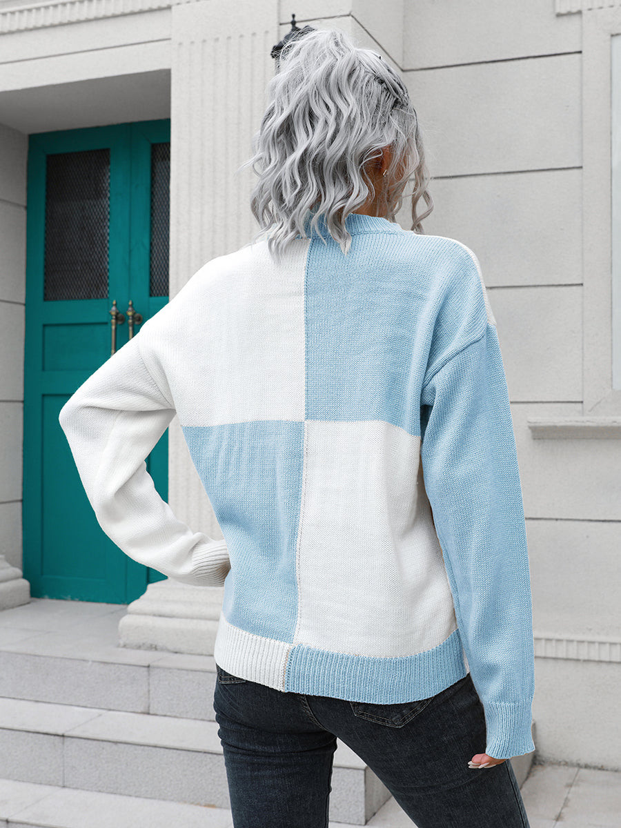Colorblock knit sweater with checkerboard pattern in pastel blue and white acrylic.