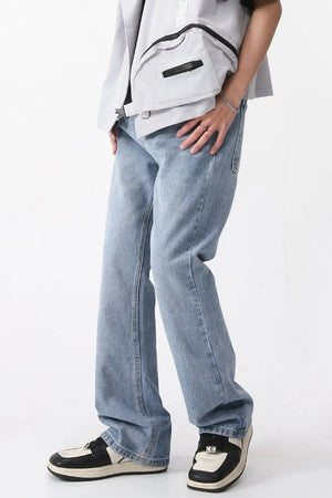 Wide-leg denim jeans in medium wash with carpenter pockets.