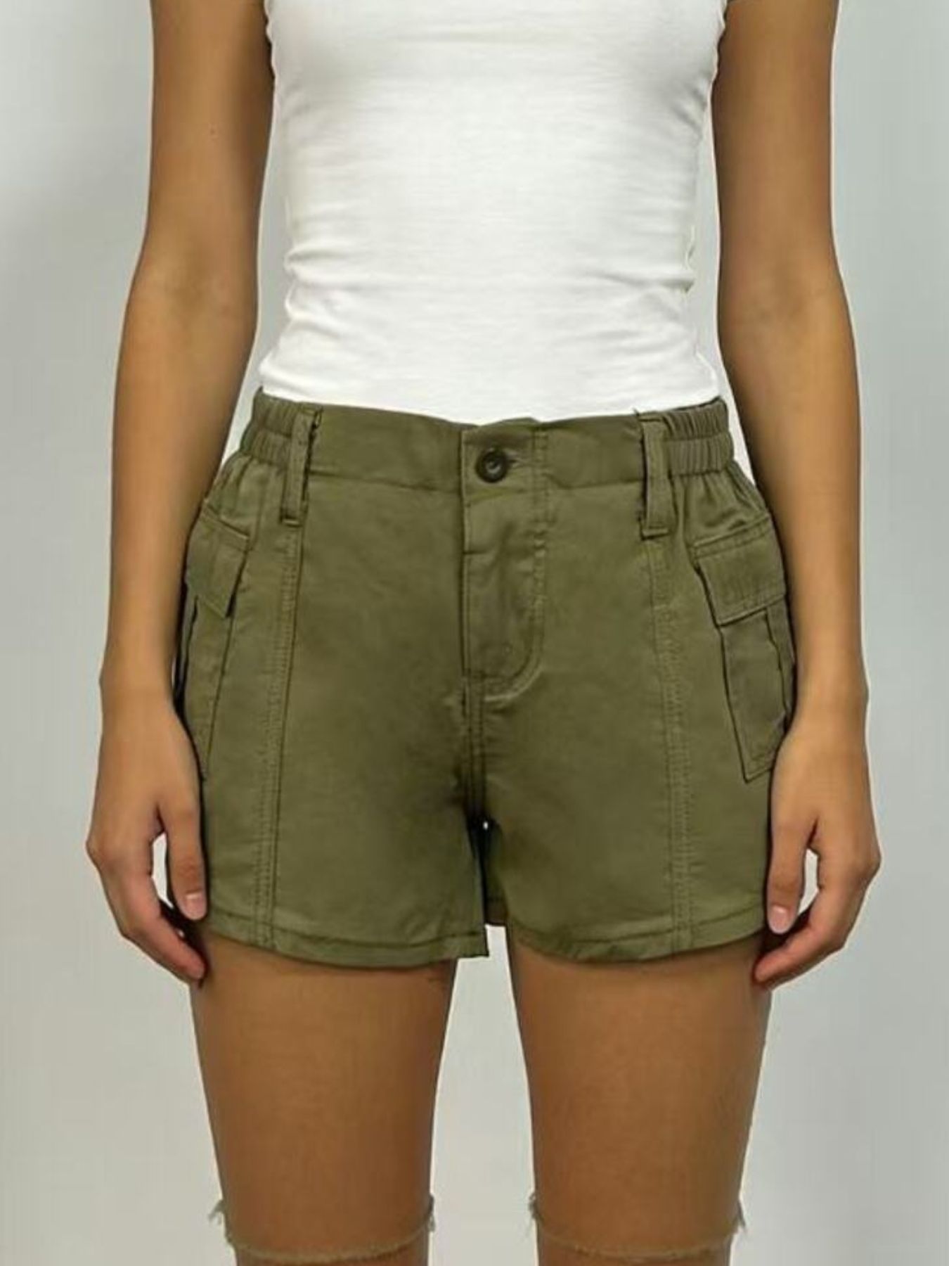 Green cargo shorts with button closure and multiple pockets.