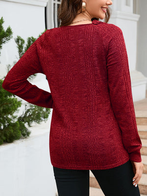 Textured raglan sleeve knit top in wine with a subtle vertical pattern.