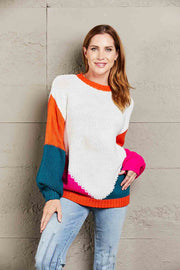 Colorblock knit sweater with sculpted sleeves in white, orange, teal, and pink acrylic.