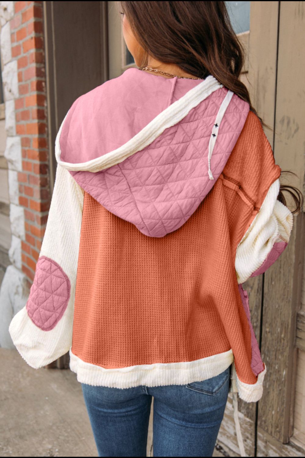 Colorblock hooded waffle jacket in dusty pink with quilted details and elbow patches.