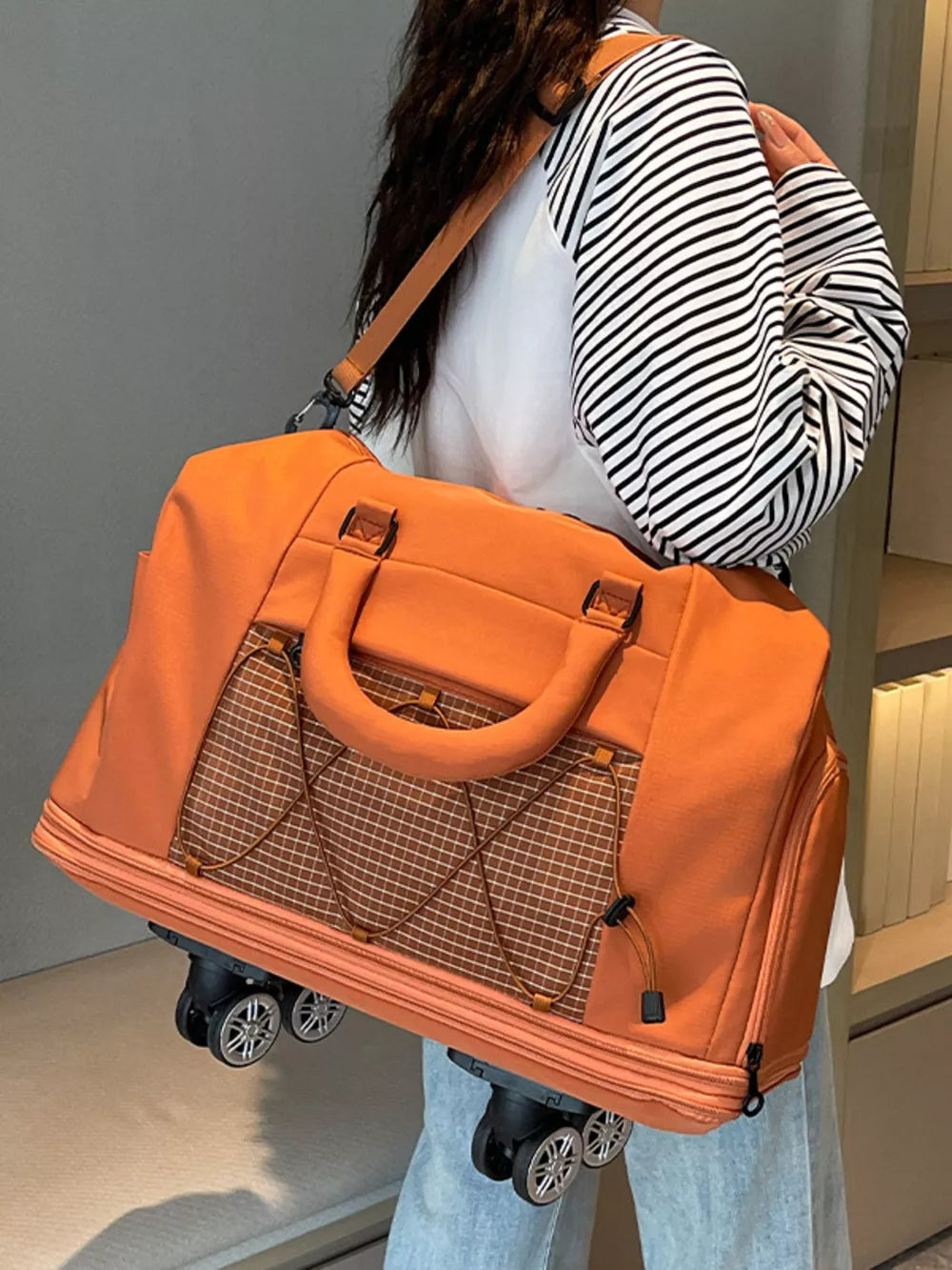 Orange rolling travel organizer bag with mesh pocket and wheels