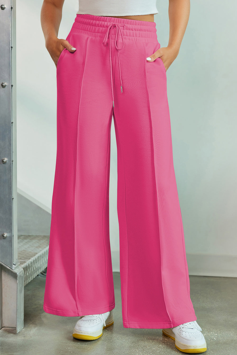 Hot Pink palazzo joggers with center seam detail, drawstring waist, and pockets.