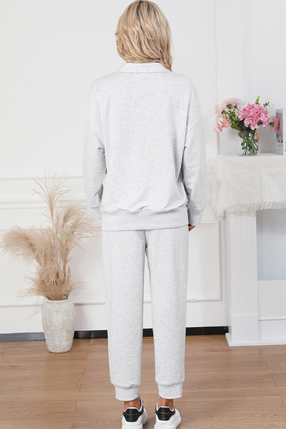 Light gray quarter-zip loungewear set with a collared neckline and cuffed joggers.