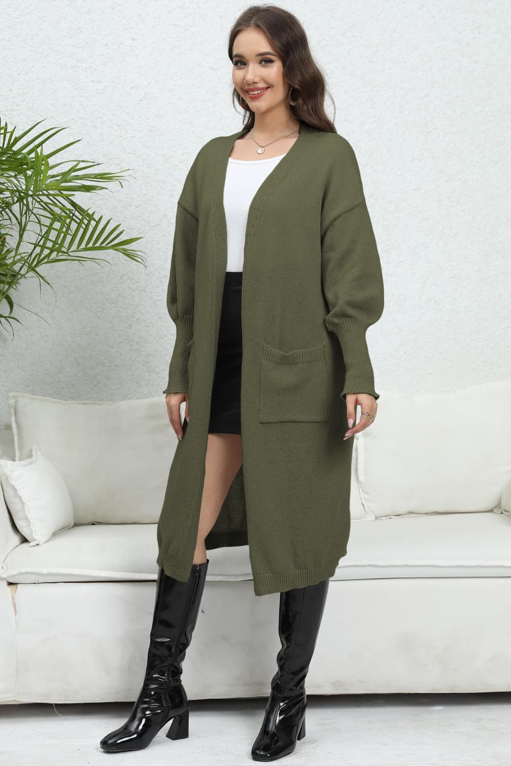 Oversized Army Green knit cardigan with pockets and V-neckline, long sleeves.