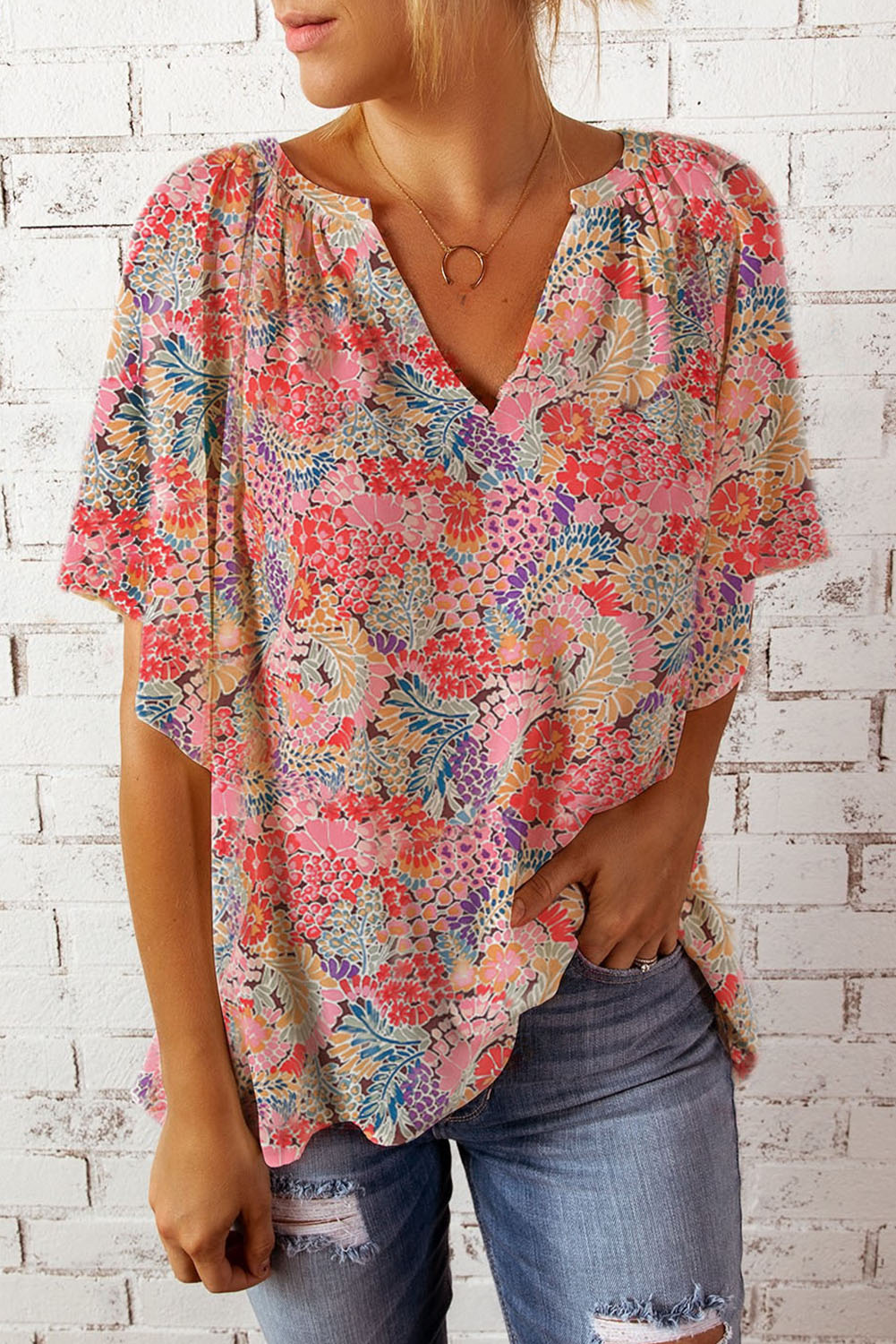 Floral dolman sleeve blouse with a v-neck and gathered neckline.