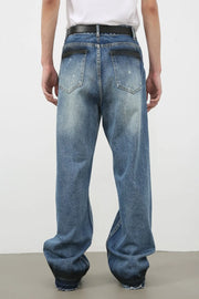 Panelled denim palazzo trousers in medium wash with distressed details and wide legs.