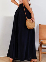 Black gathered waist palazzo pants with a flowing wide leg.