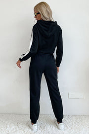 Black cropped tracksuit with contrast white stripe detail on sleeves and pants.