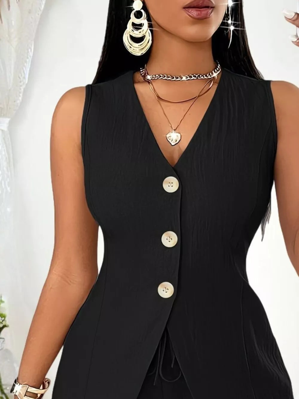 Black button-down vest with V-neck and drawstring detail, part of a set.