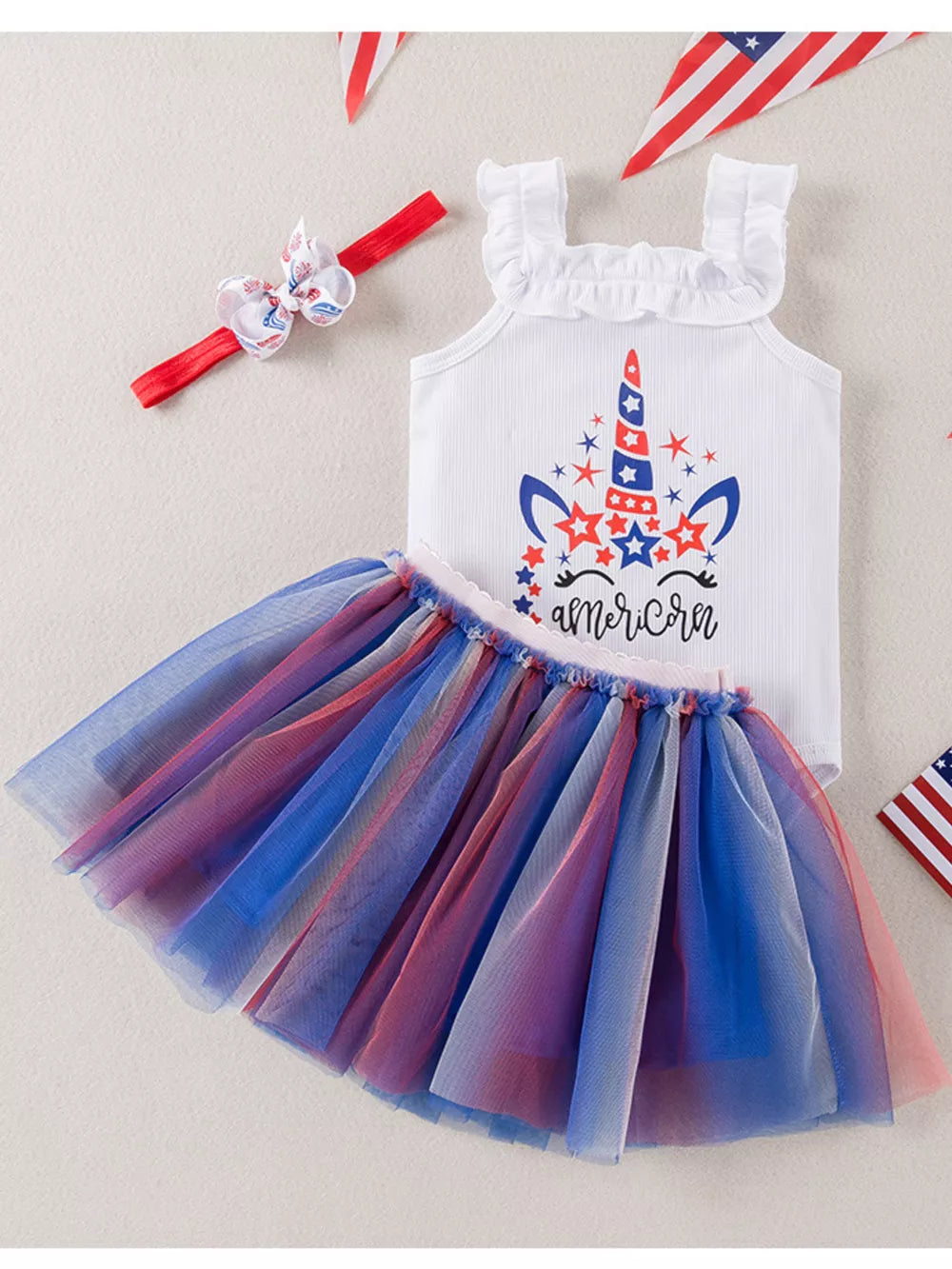 Star-spangled unicorn tutu dress with ruffled straps and red, white, and blue tulle skirt.