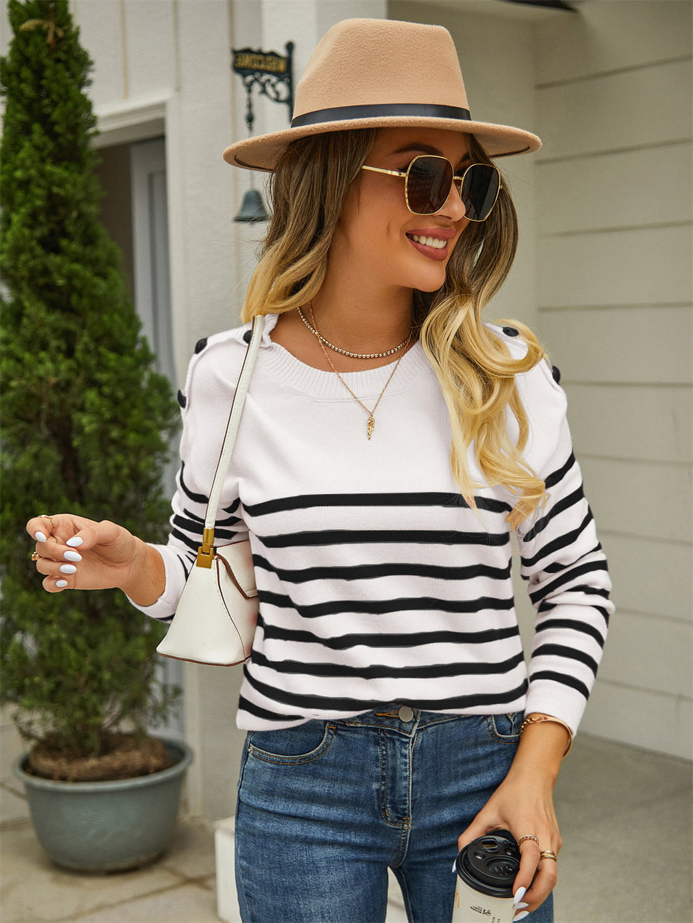 White and black striped acrylic sweater with shoulder buttons.