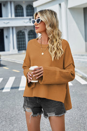 Caramel acrylic knit sweater with flared sleeves and slit hem detail.