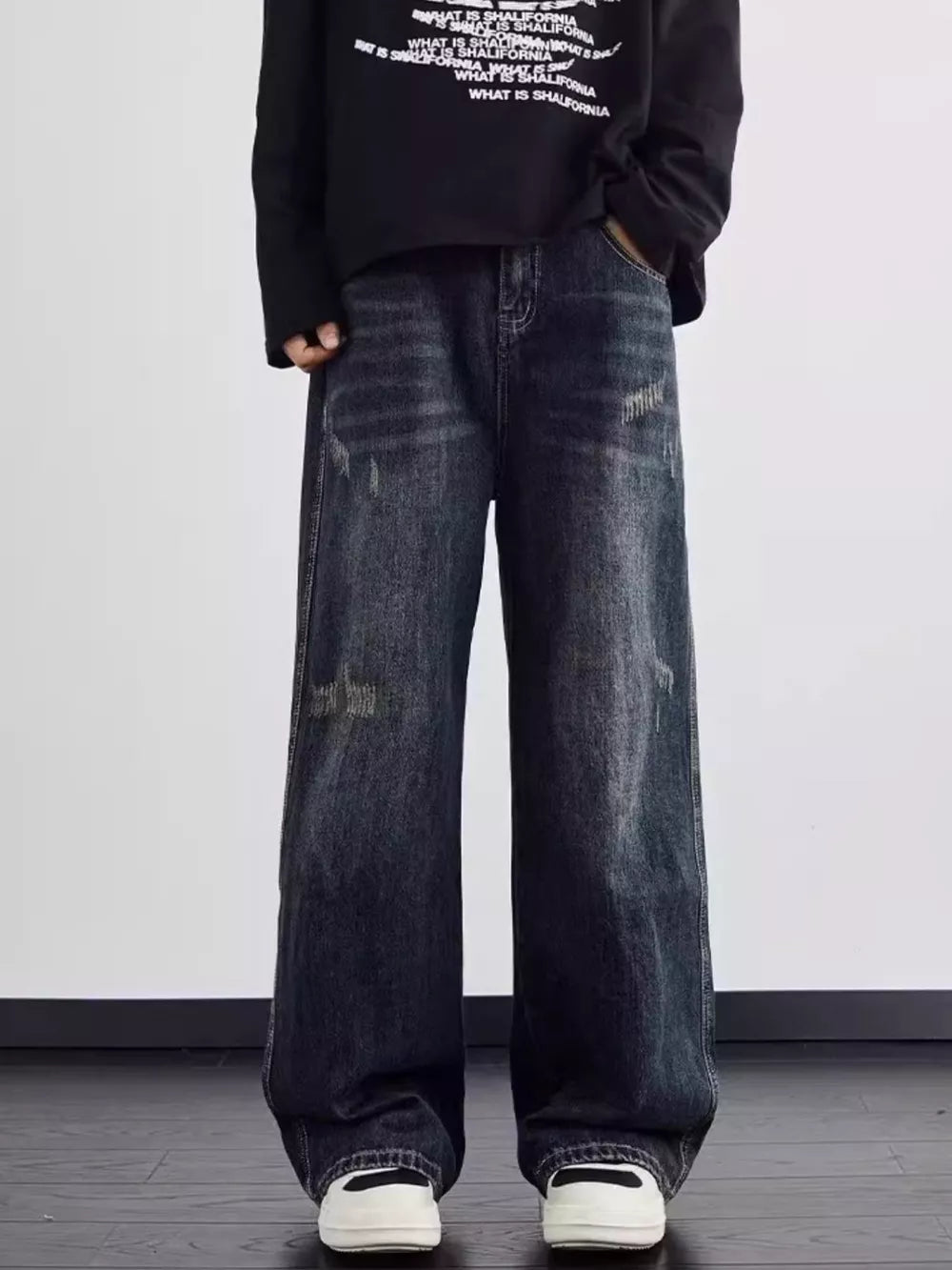 Men's dark wash wide leg jeans with distressed details and a relaxed fit.