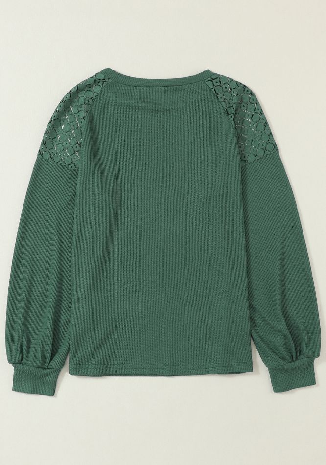 Green waffle knit raglan top with lace yoke and balloon sleeves.