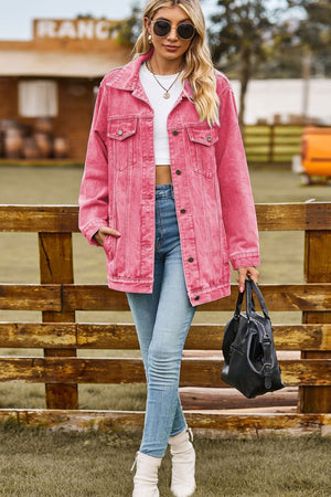 Oversized coral denim trucker jacket with classic buttoned front and chest pockets.