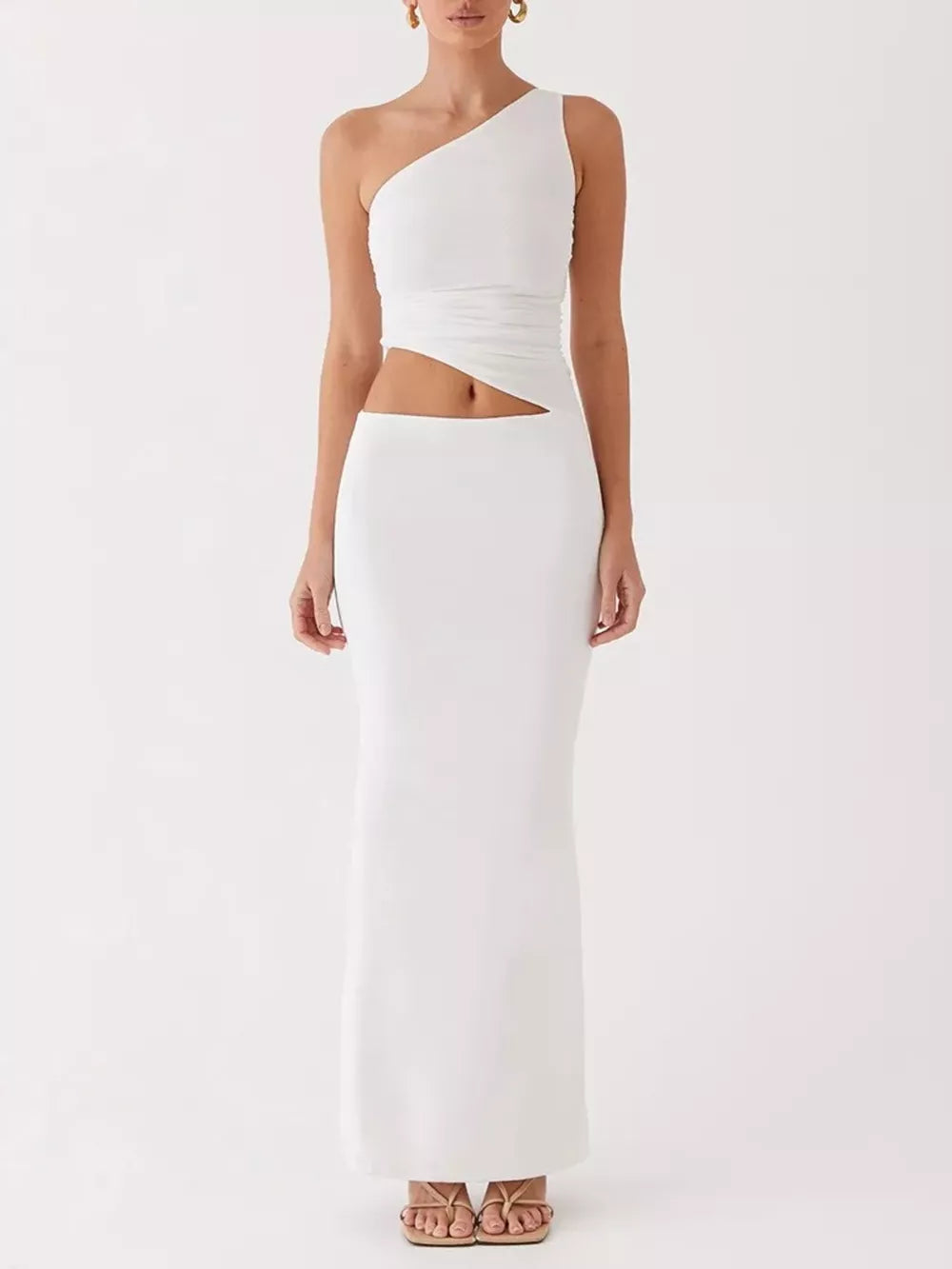 White one-shoulder cutout maxi maternity dress with a ruched bodice and fitted skirt.