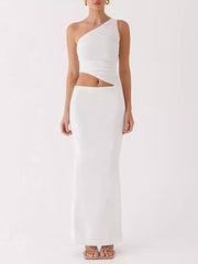 White one-shoulder cutout maxi maternity dress with a ruched bodice and fitted skirt.