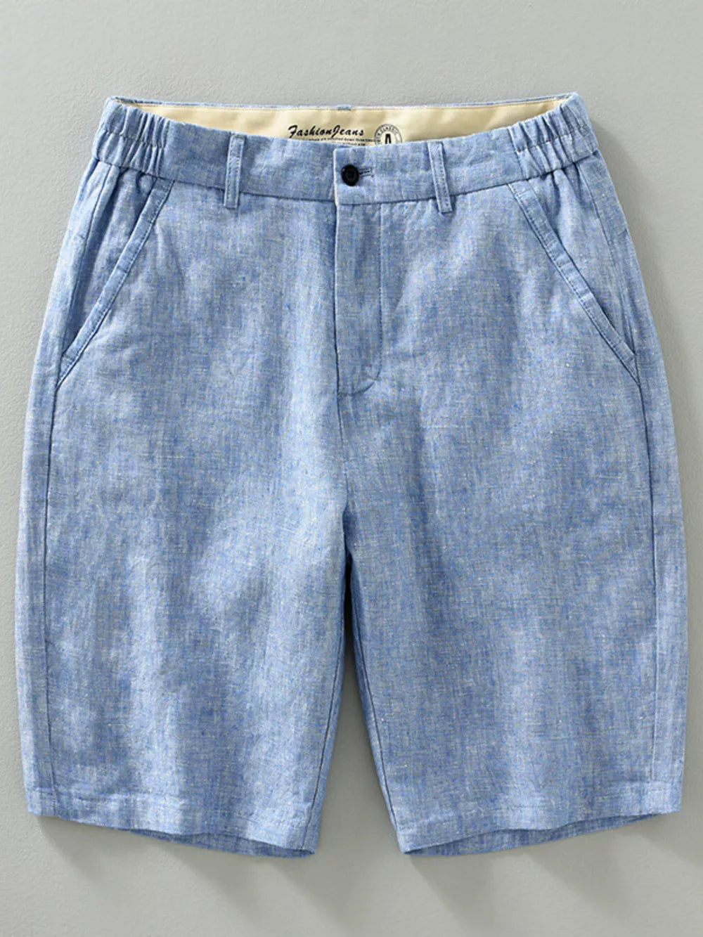 Light blue chino shorts with elastic waistband and pockets.