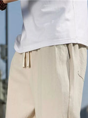Men's khaki sweatpants with drawstring waist and pockets.