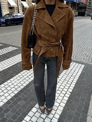 Brown faux suede bolero jacket with tie waist and lapel collar.