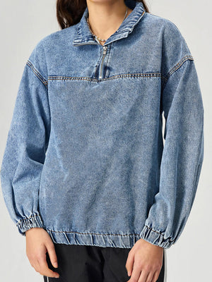 Acid wash denim pullover with quarter zip and elastic cuffs.