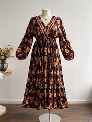 Maxi dress with V-neck, long sleeves, tiered skirt, and floral print.