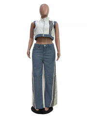 White zip-front crop top with black stripes and wide-leg jeans with side stripe detail.