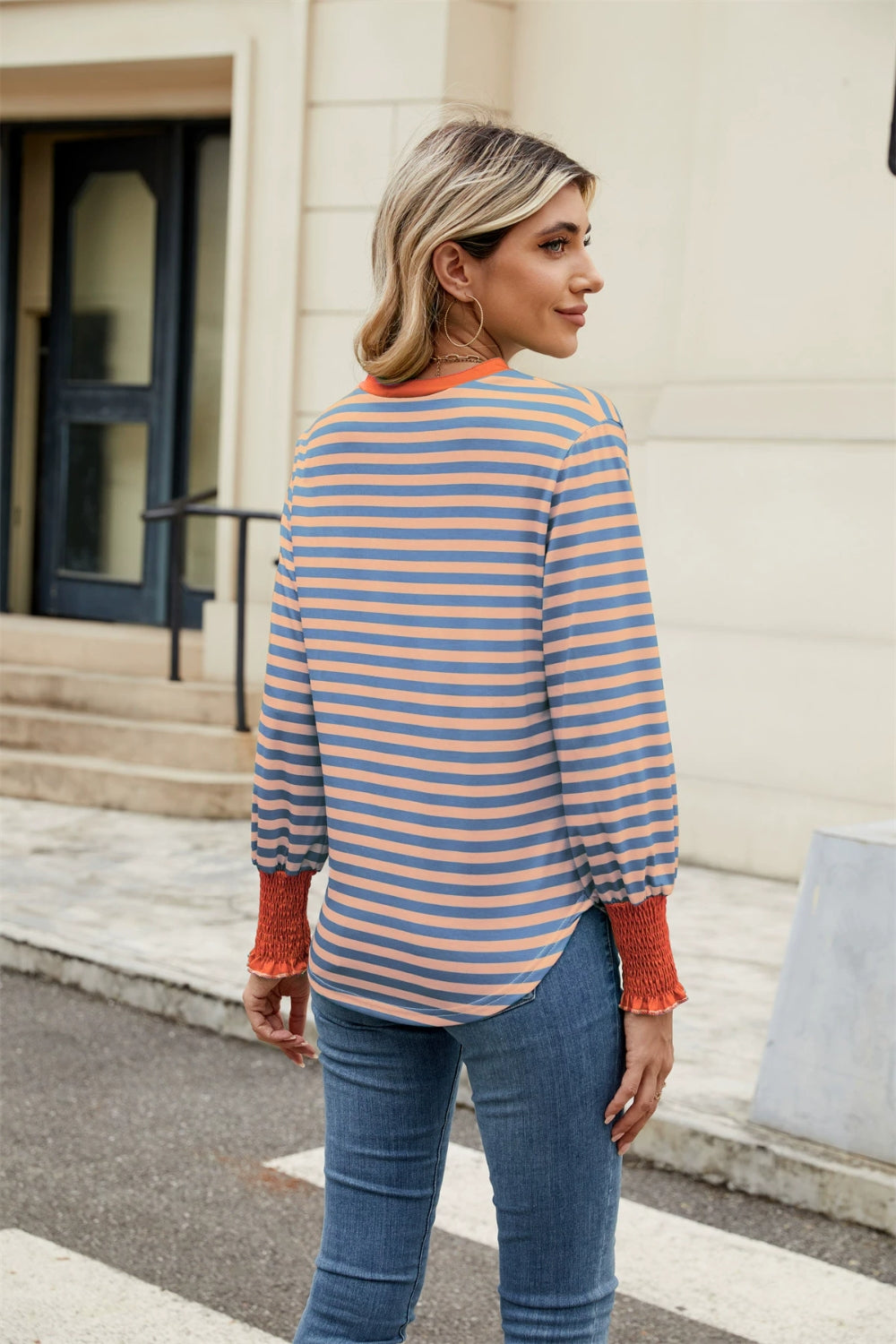 Striped long sleeve blouse with orange neckline and cuffs, blue and orange stripes