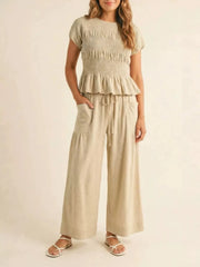 Smocked Peplum Top And Wide-leg Pants Set in Terracotta, model styling view