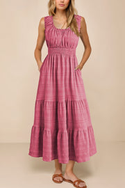 Deep rose smocked midi dress with tiered skirt and pockets.