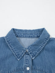 Ruffled denim button-up shirt with a classic collar and button closure.