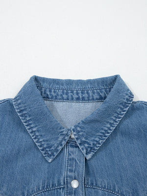 Ruffled denim button-up shirt with a classic collar and button closure.
