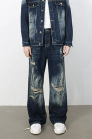 Oversized distressed dark wash denim jeans with wide legs and ripped details.