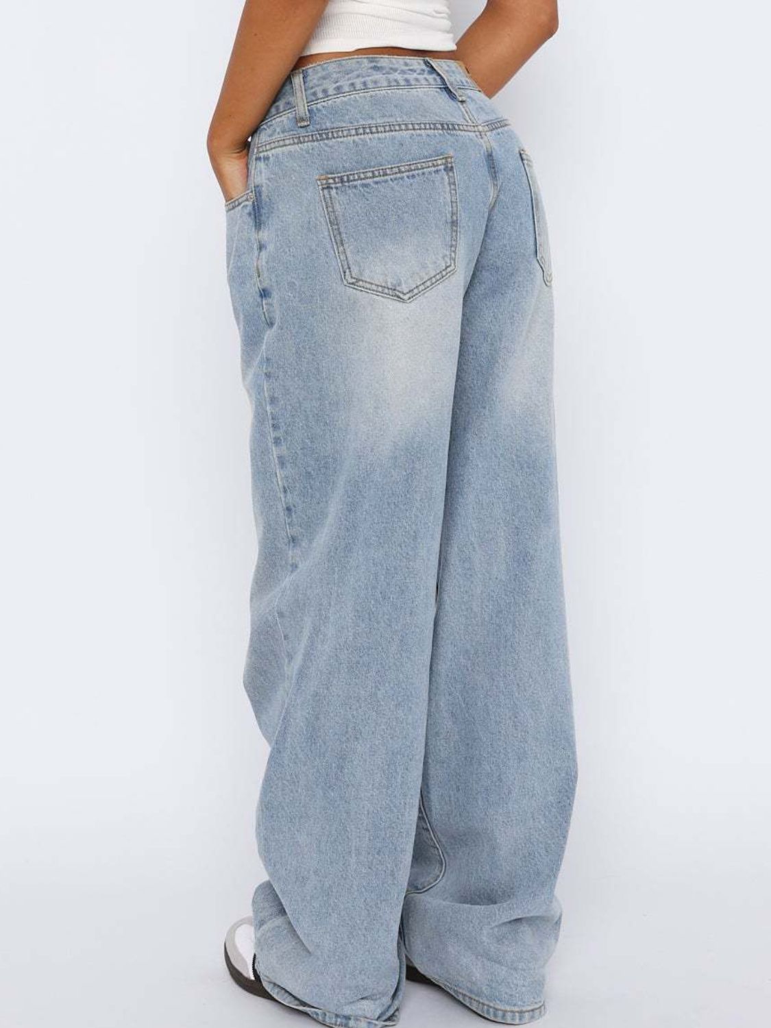 Light blue wide-leg denim jeans with contrast stitching and a relaxed fit.
