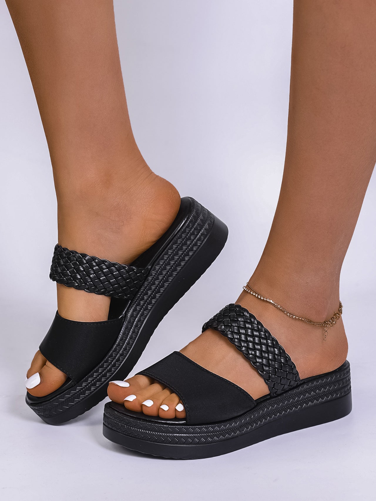 Black two-strap platform sandals with braided detail and chunky sole.