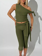 Olive green one-shoulder tie-knot top with matching capri leggings and sash detail.