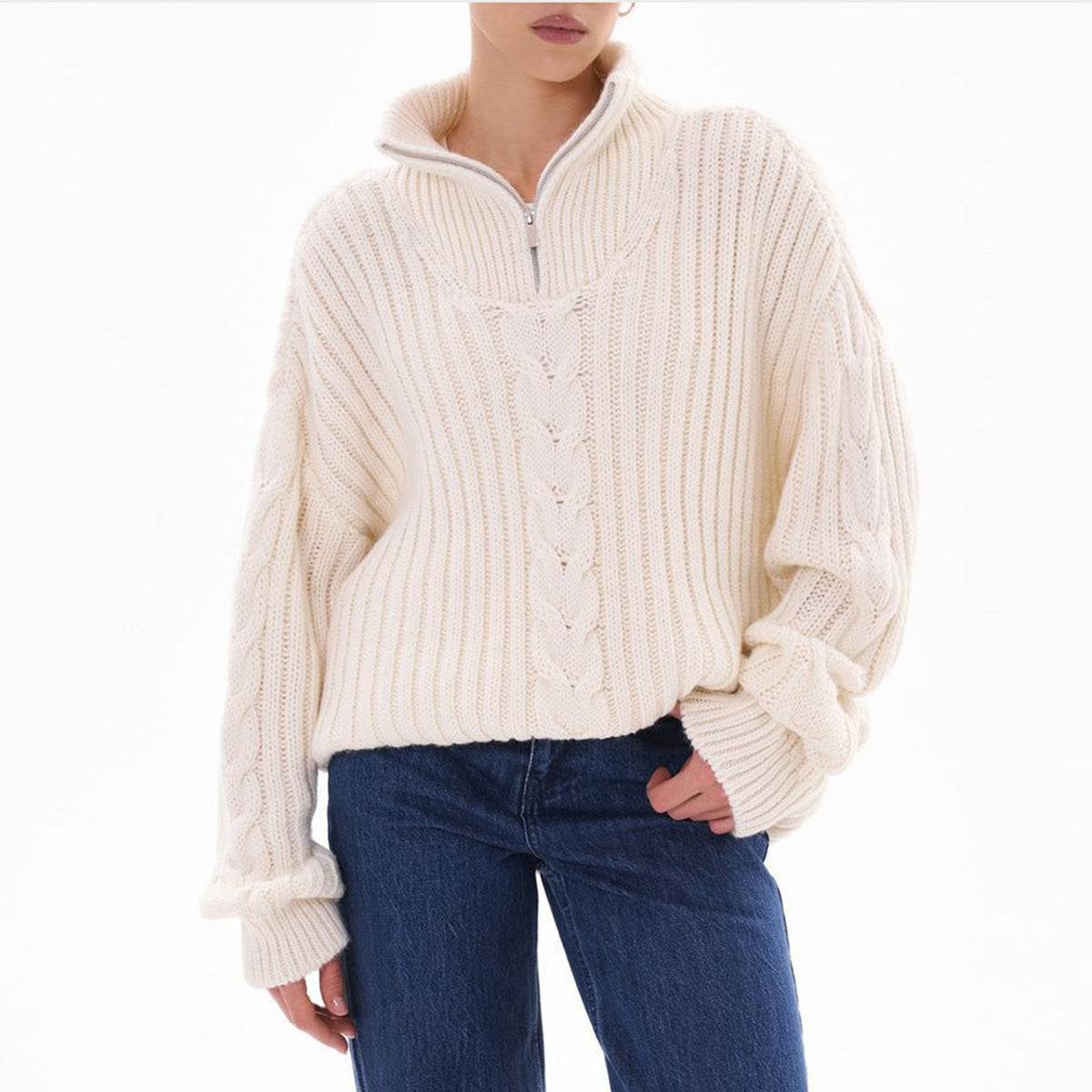 White cable knit zip-neck sweater with a relaxed fit and ribbed cuffs.