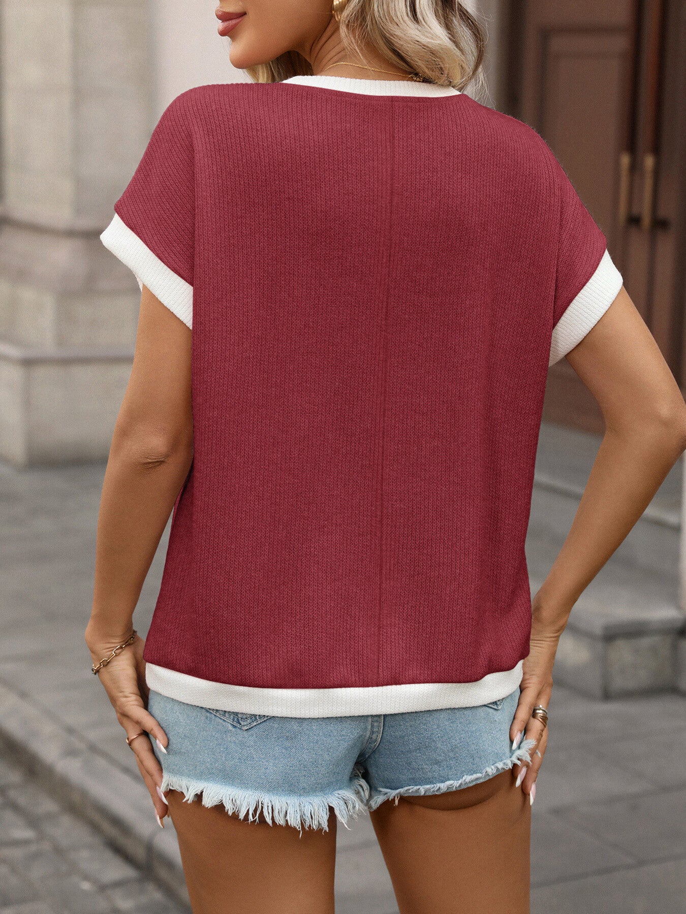 Textured knit short-sleeve t-shirt in Wine Red with white trim, crew neck, and contrast sleeves.