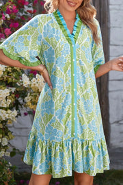 Charming floral mini dress with button front, ruffled neckline, sleeves, and hem.